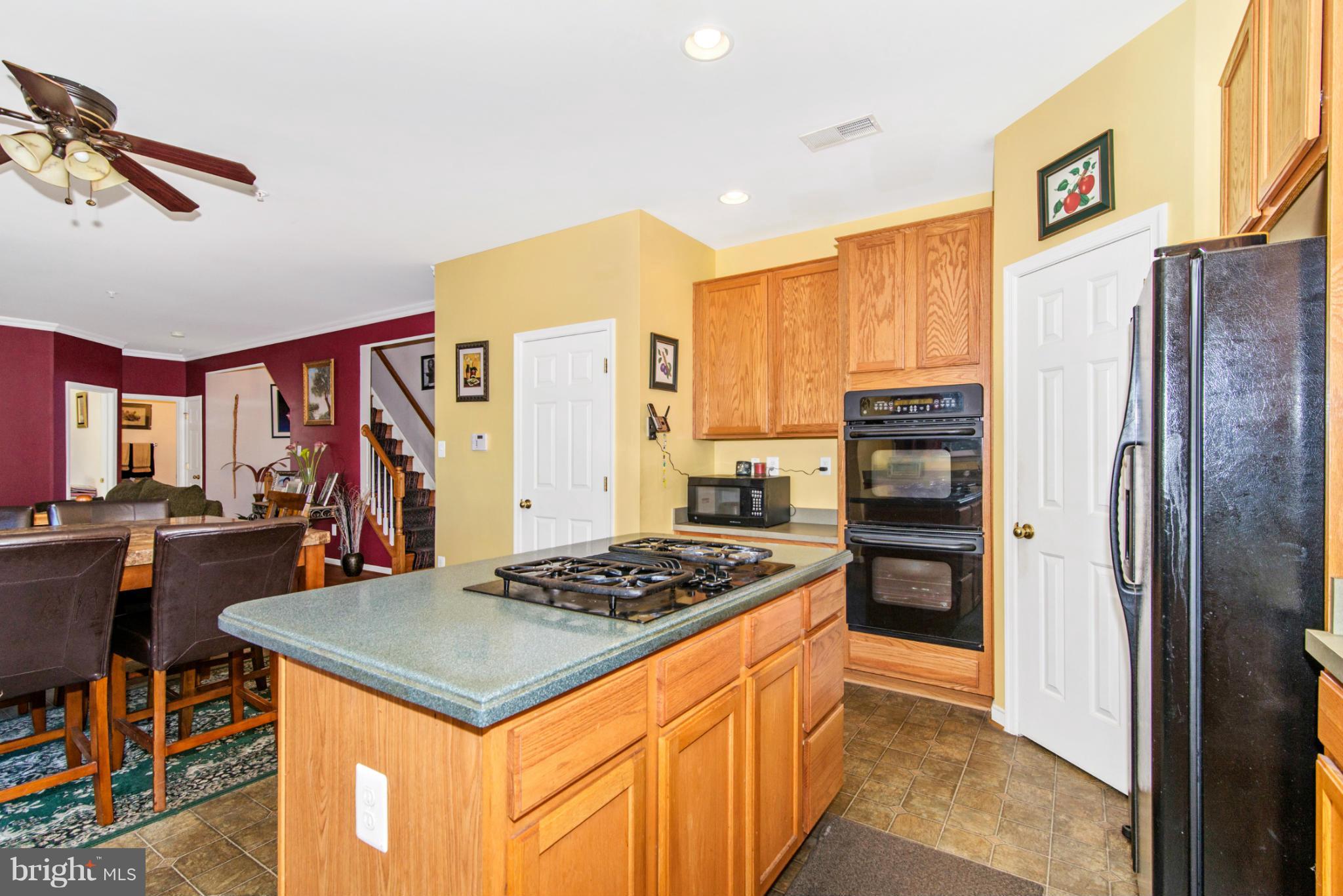 14625 Bubbling Spring Road Boyds, MD 20841 - Photo 10 of 30 a kitchen with stainless steel appliances granite countertop a stove refrigerator and cabinets