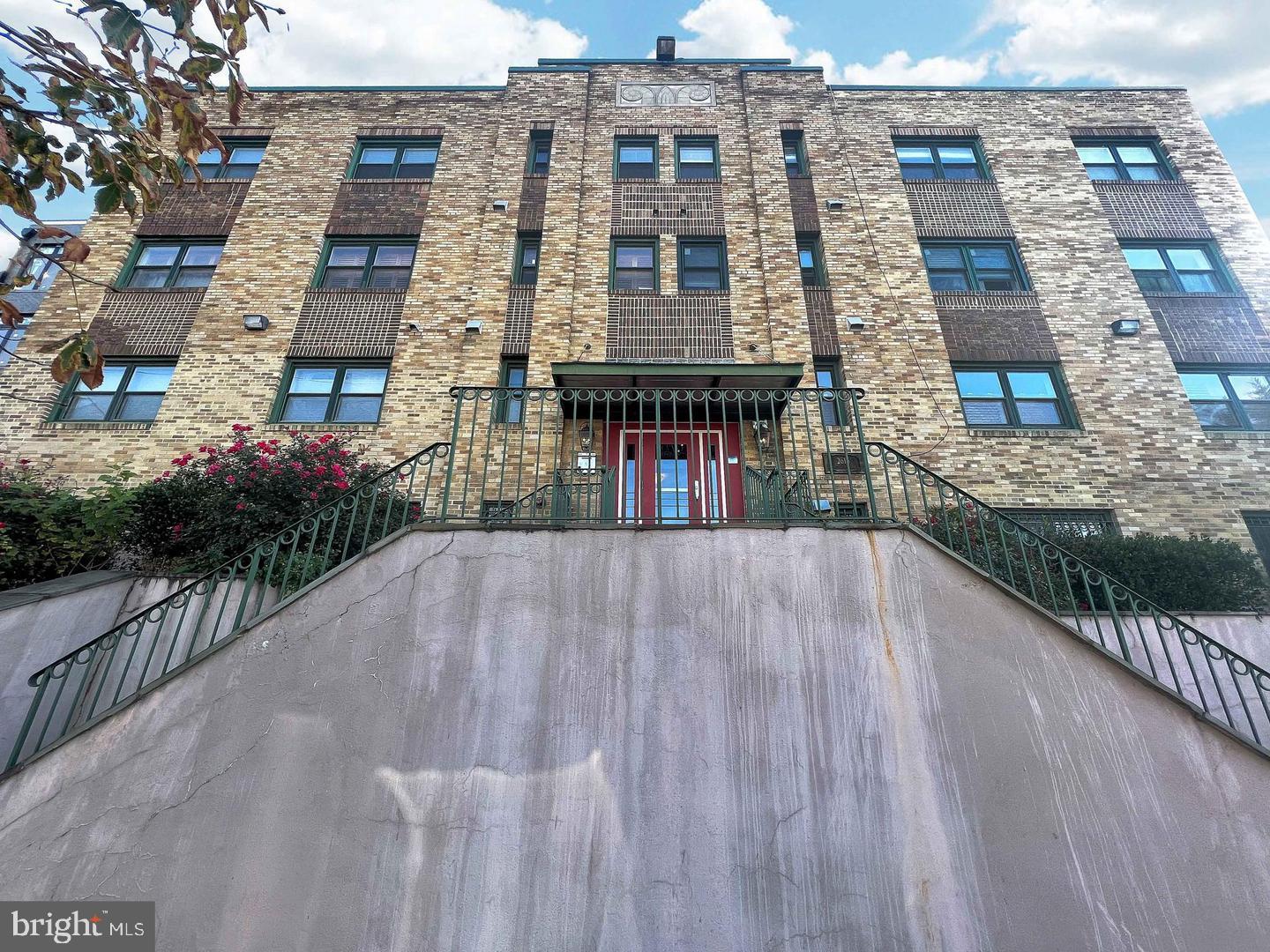 a view of a brick building next to a yard
