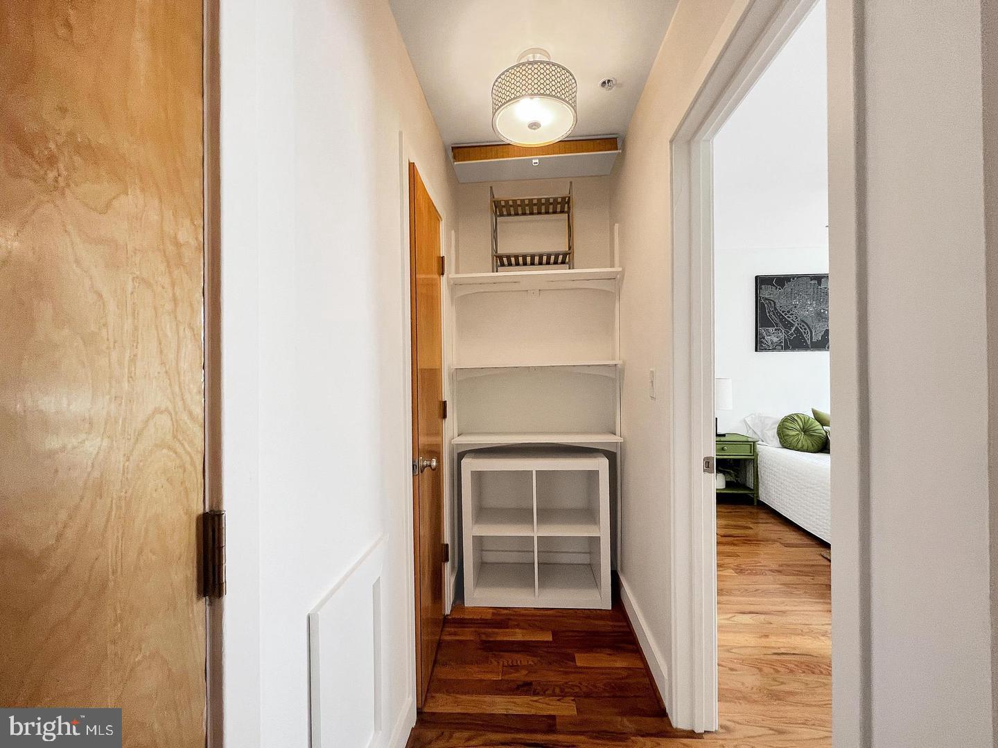 2615 4th Street Northeast, Unit 306 Washington, DC 20002 - Photo 12 of 13 a view of a hallway with wooden floor and a living room