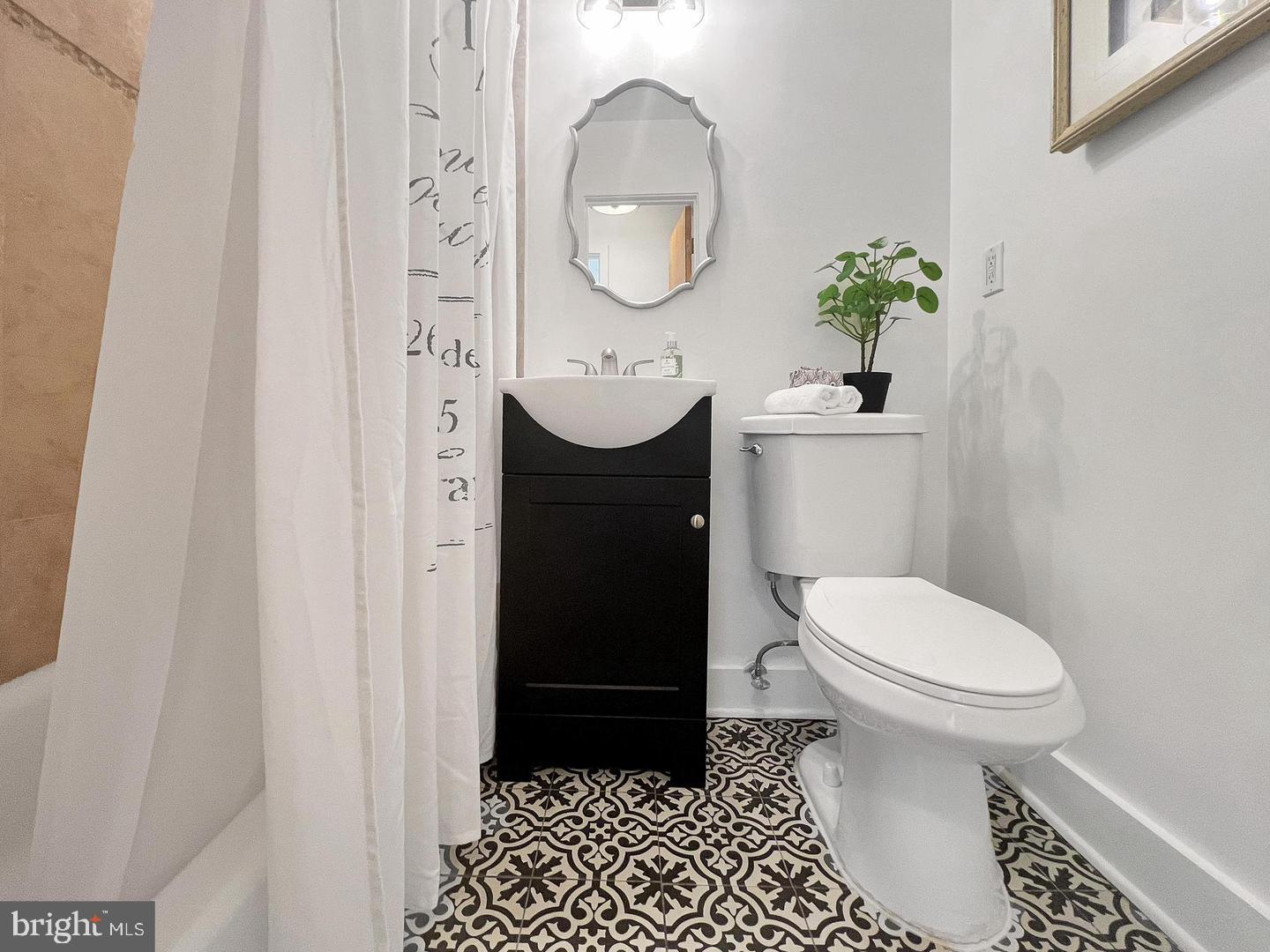 2615 4th Street Northeast, Unit 306 Washington, DC 20002 - Photo 13 of 13 a bathroom with a toilet a sink and a mirror