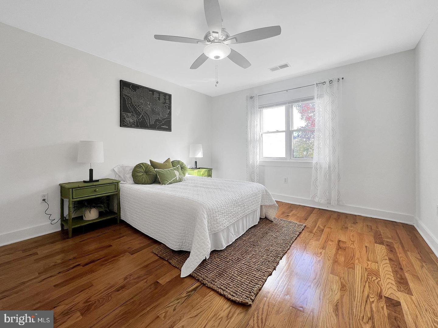 2615 4th Street Northeast, Unit 306 Washington, DC 20002 - Photo 7 of 13 a bedroom with wooden floor and a bed
