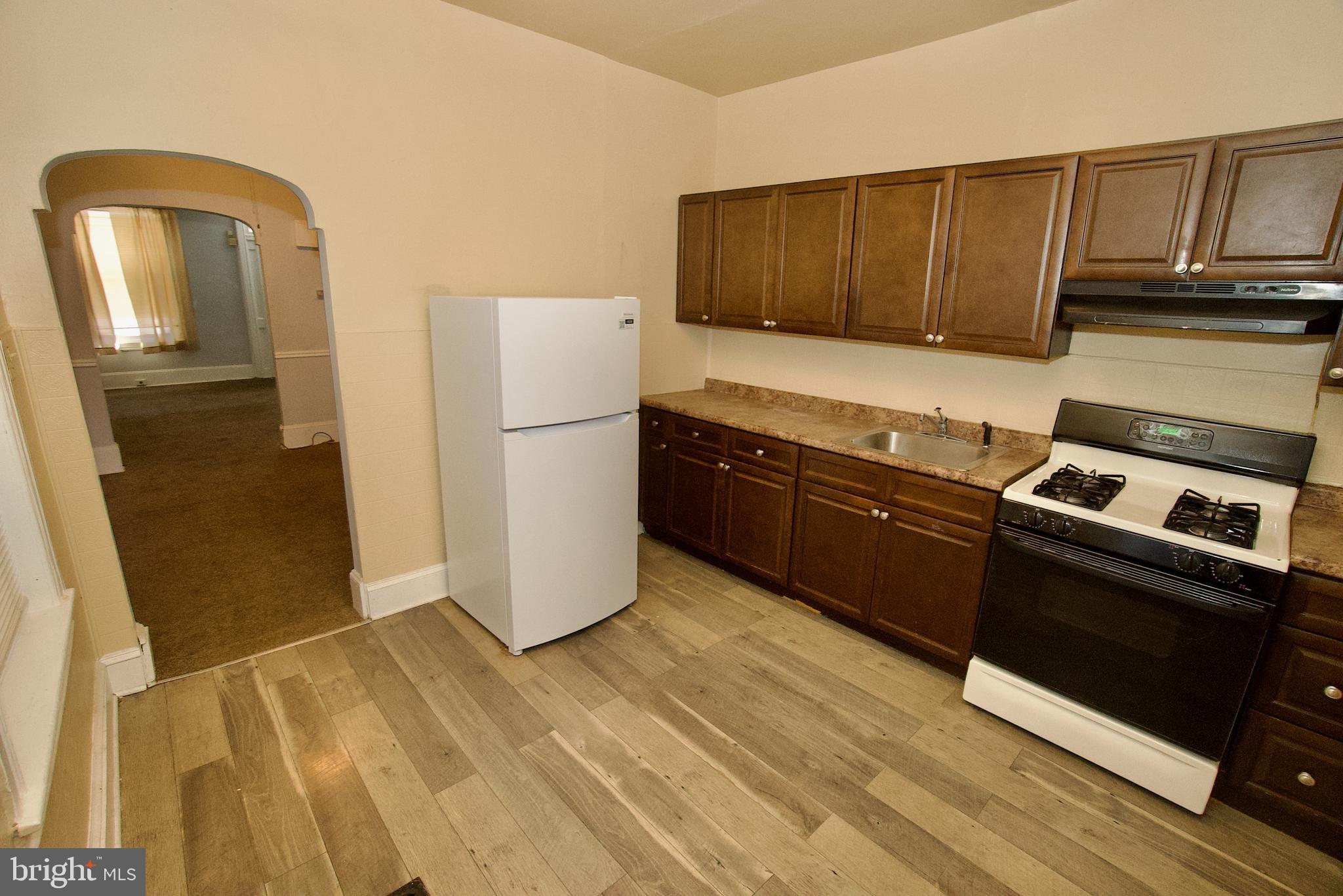 1361 East Rittenhouse Street Philadelphia, PA 19138 - Photo 6 of 20 a kitchen with granite countertop wooden cabinets and a stove top oven
