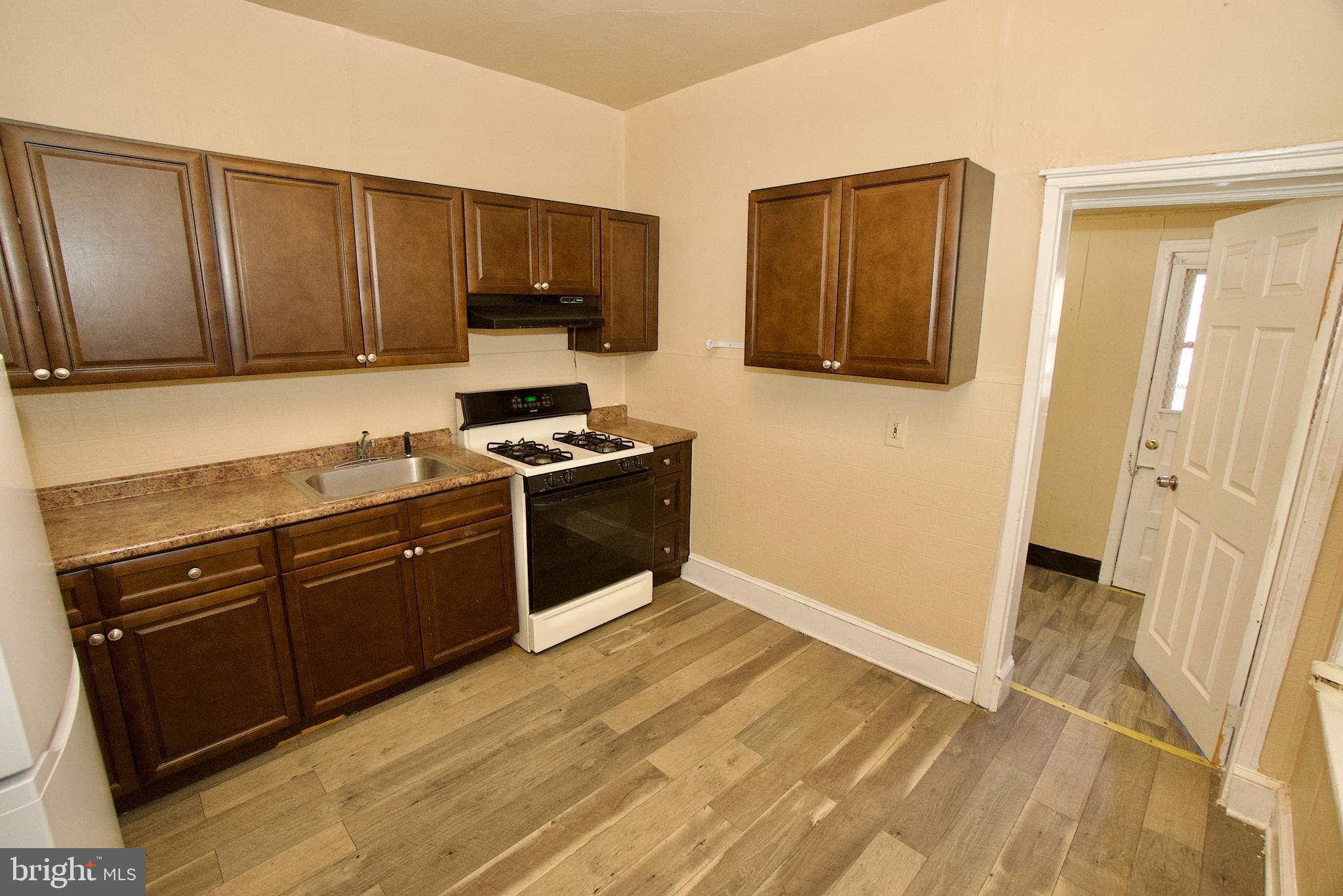 1361 East Rittenhouse Street Philadelphia, PA 19138 - Photo 7 of 20 a kitchen with wooden cabinets and a stove top oven