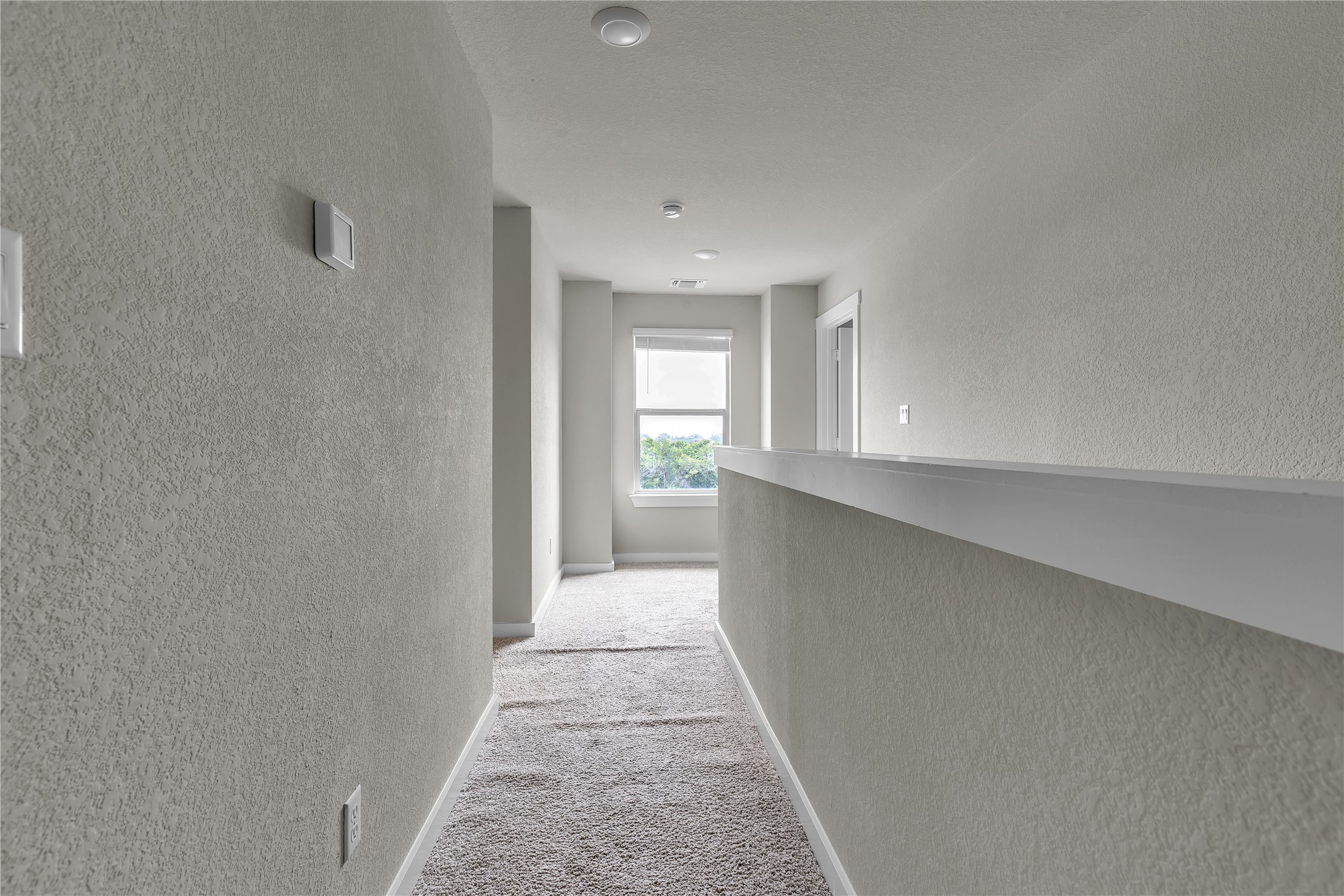 1212 Tipton Street Georgetown, TX 78633 - Photo 8 of 20 Well-lit upper-level hallway features soft carpet and a window at the far end.