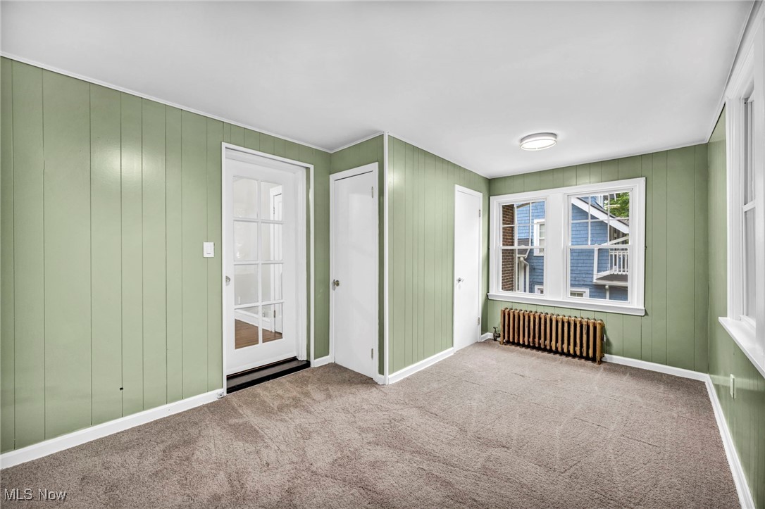 2980 East Overlook Road Cleveland, OH 44118 - Photo 22 of 49 Carpeted spare room with radiator heating unit