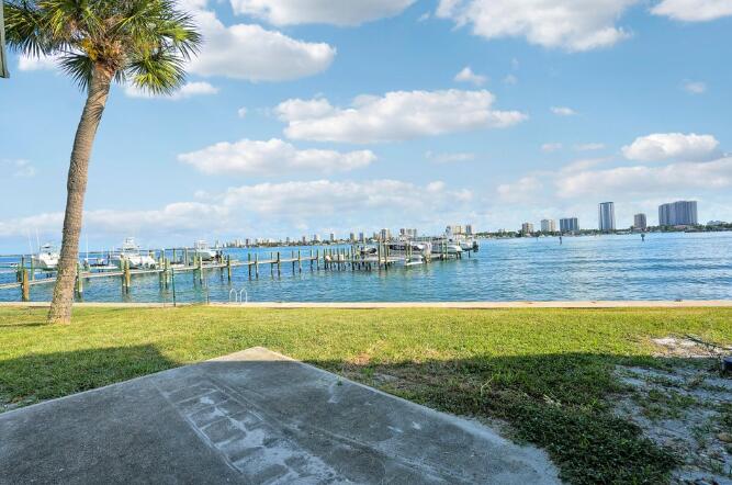 360 Wilma Circle, Unit 6 Riviera Beach, FL 33404 - Photo 13 of 13 a view of a lake with a big yard and large trees