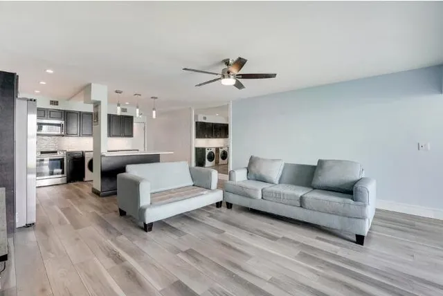a living room with furniture and a wooden floor