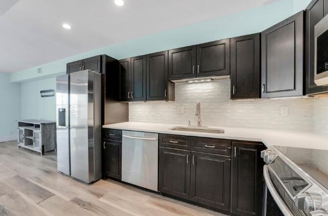 360 Wilma Circle, Unit 6 Riviera Beach, FL 33404 - Photo 8 of 13 a kitchen with stainless steel appliances granite countertop a refrigerator and a sink