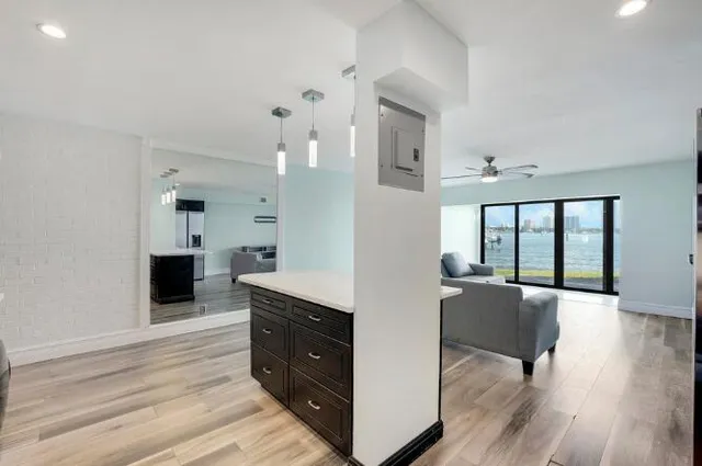 a living room with furniture and a kitchen