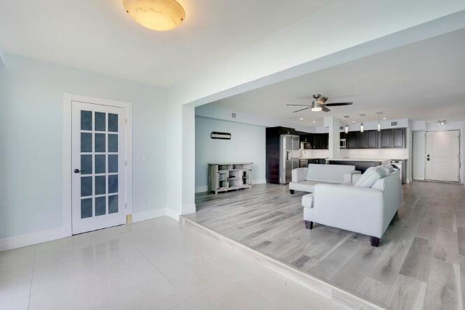 360 Wilma Circle, Unit 6 Riviera Beach, FL 33404 - Photo 10 of 13 a living room with furniture and a kitchen