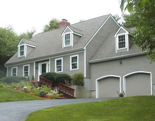 45 Jeremiah Road Newtown, CT 06482 - Photo 1 of 1 a front view of a house with a garden and plants