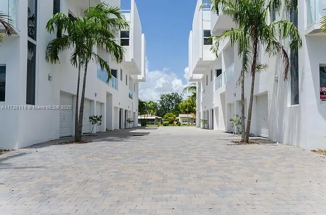 a view of a street with palm trees