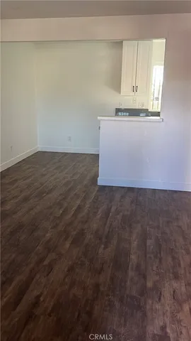 an empty room with wooden floor