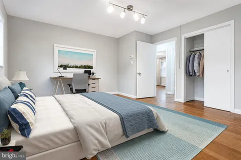 a bedroom with a bed and a television