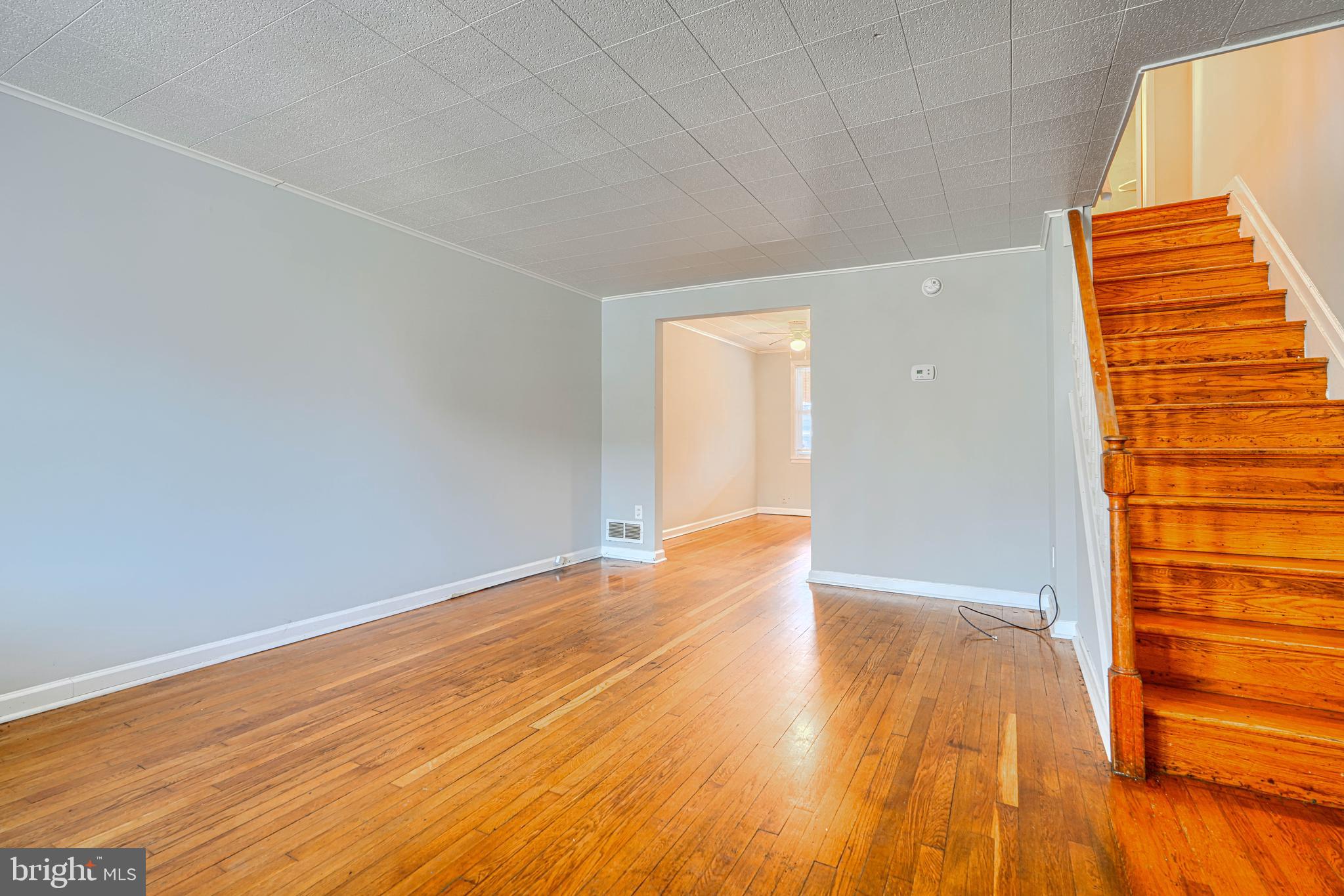 2073 Jasmine Road Baltimore, MD 21222 - Photo 4 of 29 a view of an empty room with wooden floor and a window
