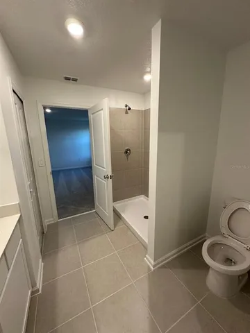 a bathroom with a glass door shower