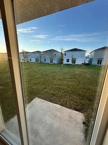 a view of a back yard from a balcony