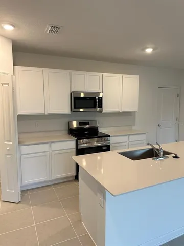 a kitchen with a sink and cabinets
