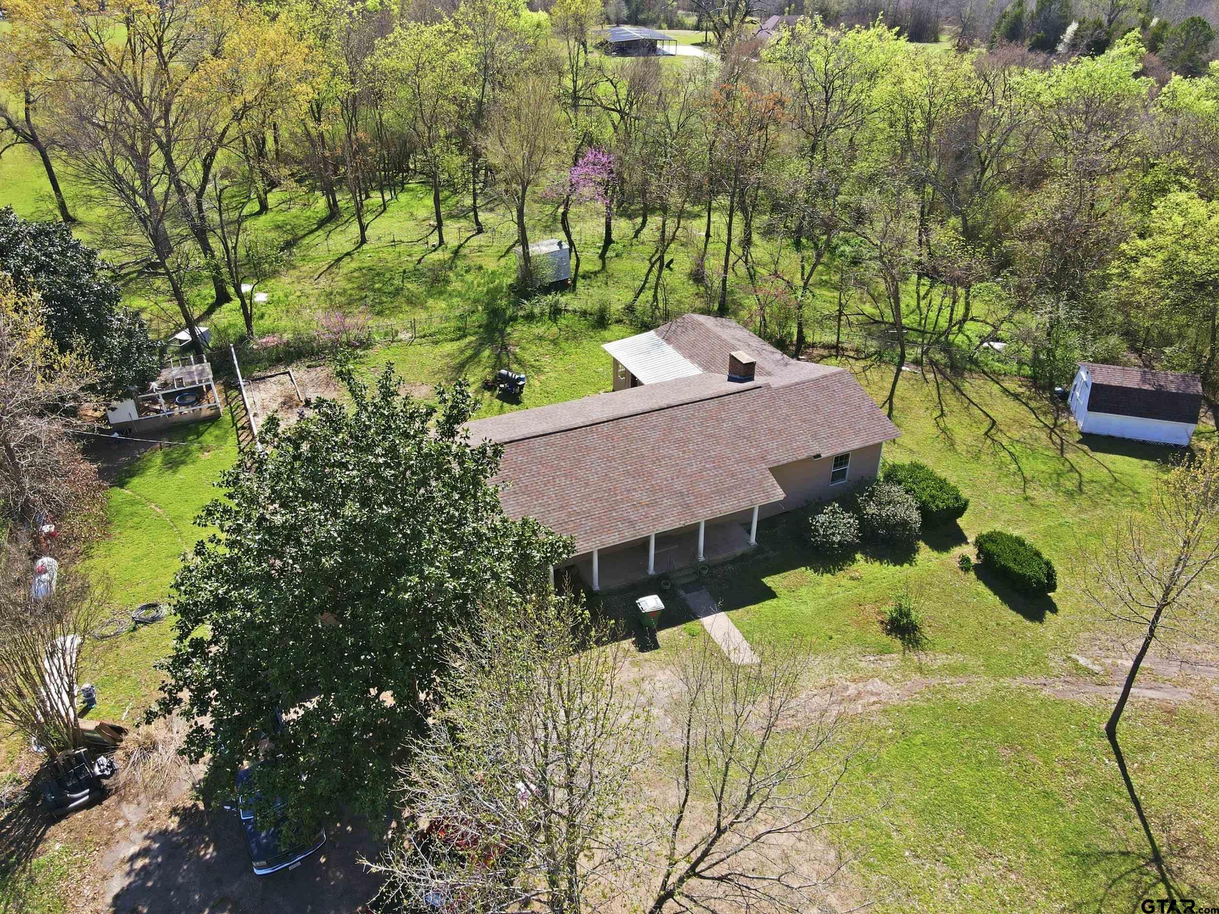 4932 Southeast Acc Road Mount Vernon, TX 75457 - Photo 28 of 35 a aerial view of a house with swimming pool and large trees