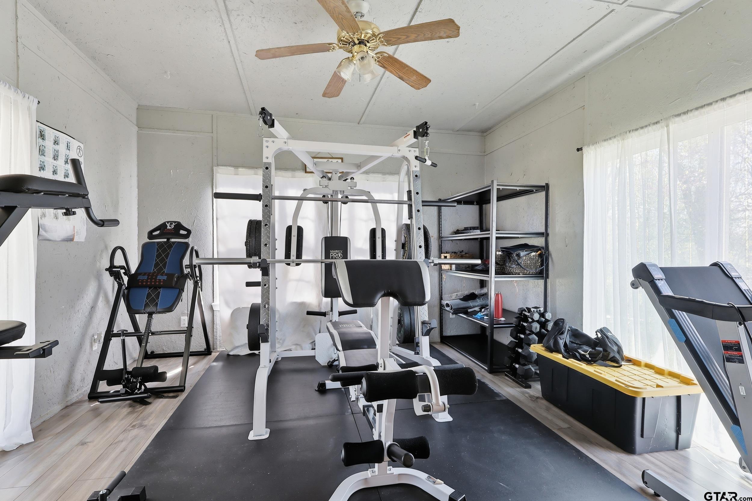 4932 Southeast Acc Road Mount Vernon, TX 75457 - Photo 8 of 35 a room with gym equipment and wooden floor