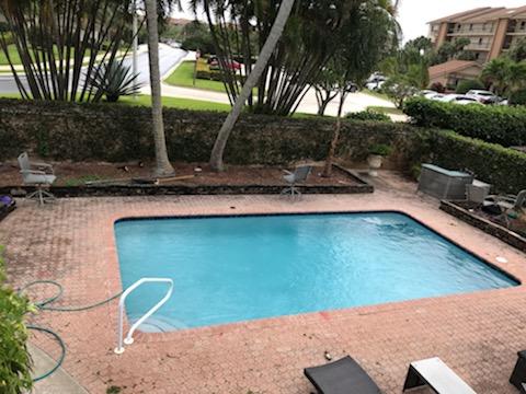 2628 Marcinski Road Jupiter, FL 33477 - Photo 14 of 18 a view of a backyard with plants and a lake view