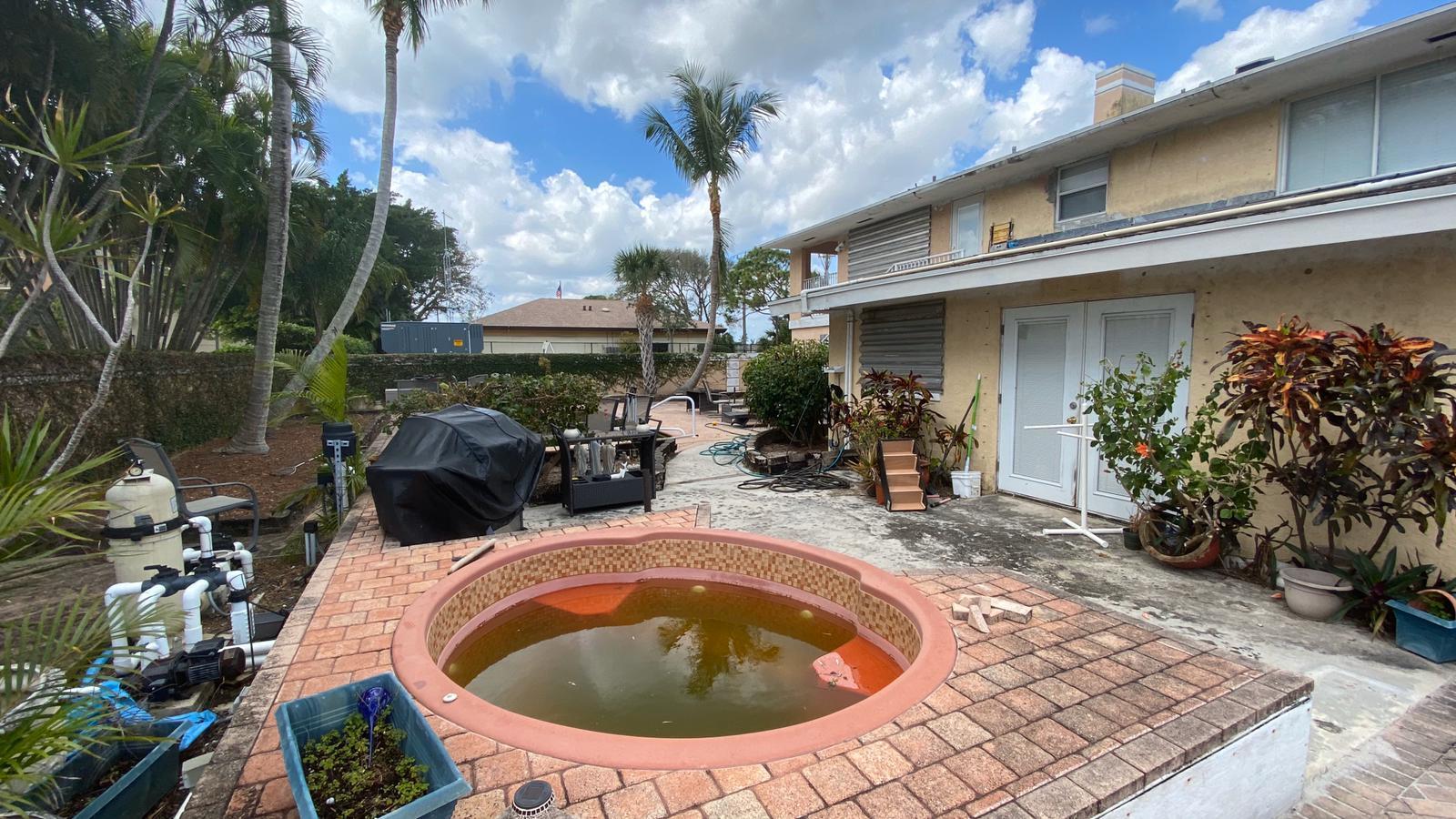 2628 Marcinski Road Jupiter, FL 33477 - Photo 16 of 18 a view of a house with swimming pool and sitting area