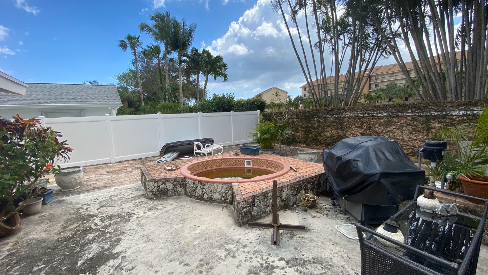 2628 Marcinski Road Jupiter, FL 33477 - Photo 17 of 18 a backyard of a house with barbeque oven fire pit table and chairs