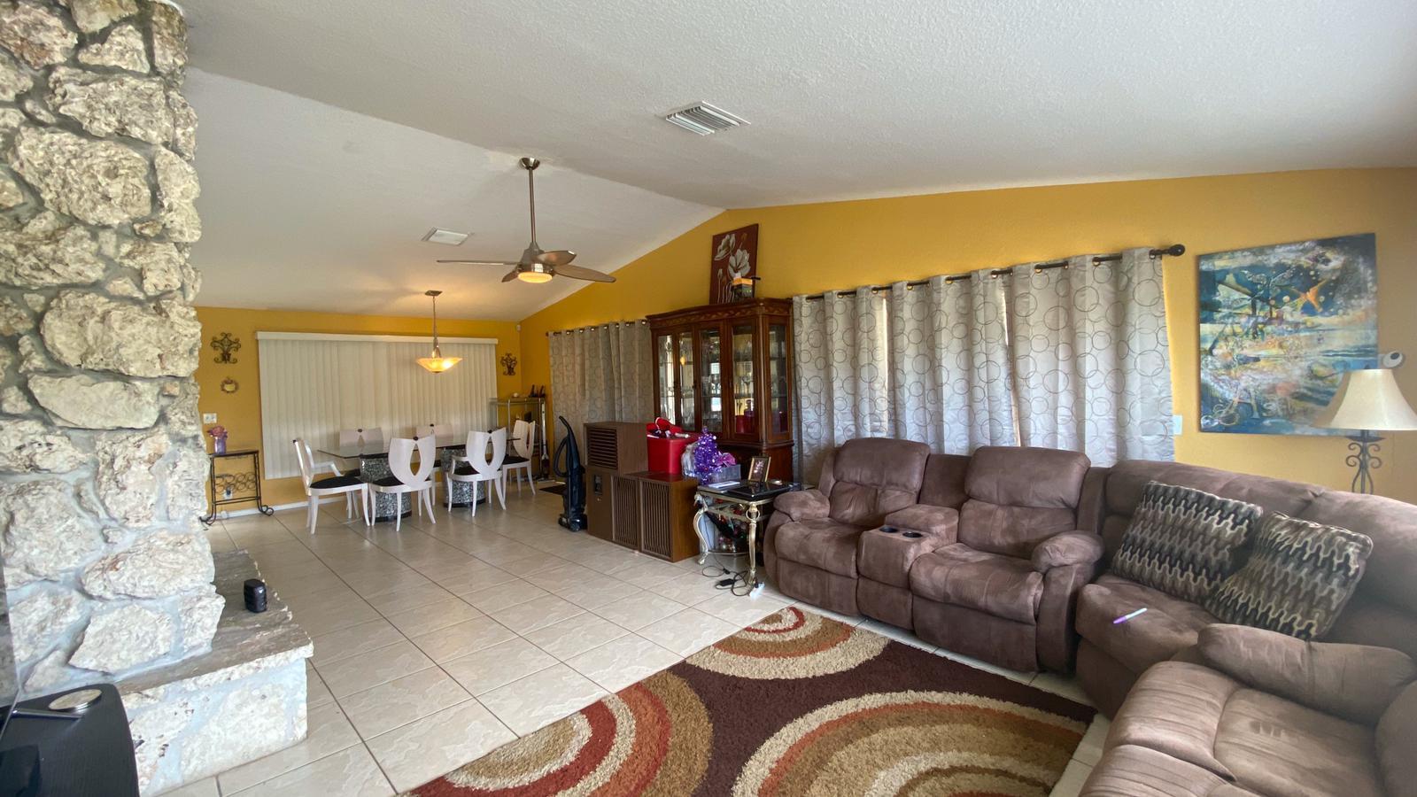 2628 Marcinski Road Jupiter, FL 33477 - Photo 3 of 18 a living room with furniture and dining area