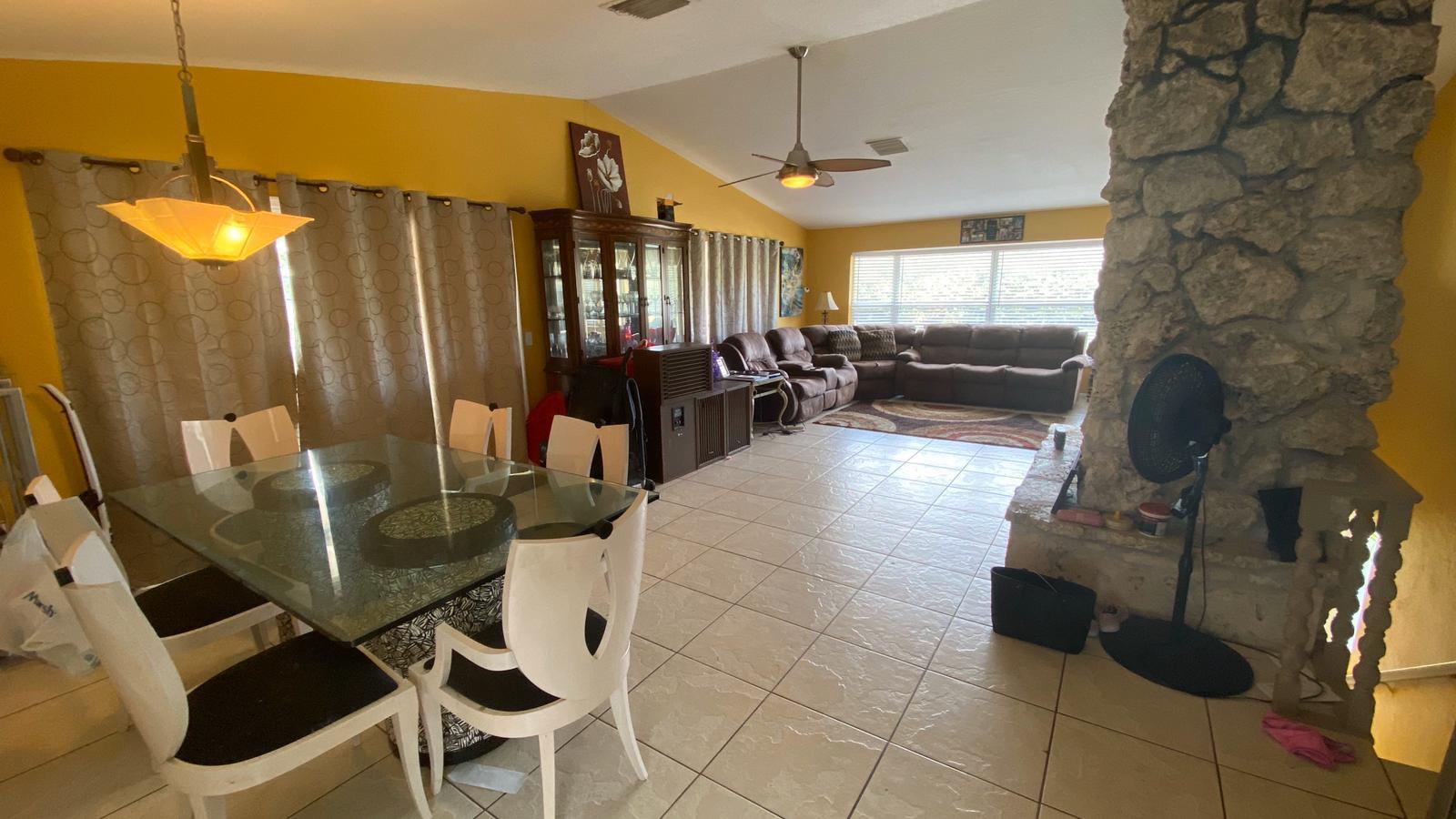 2628 Marcinski Road Jupiter, FL 33477 - Photo 5 of 18 a view of a livingroom with furniture and a floor to ceiling window