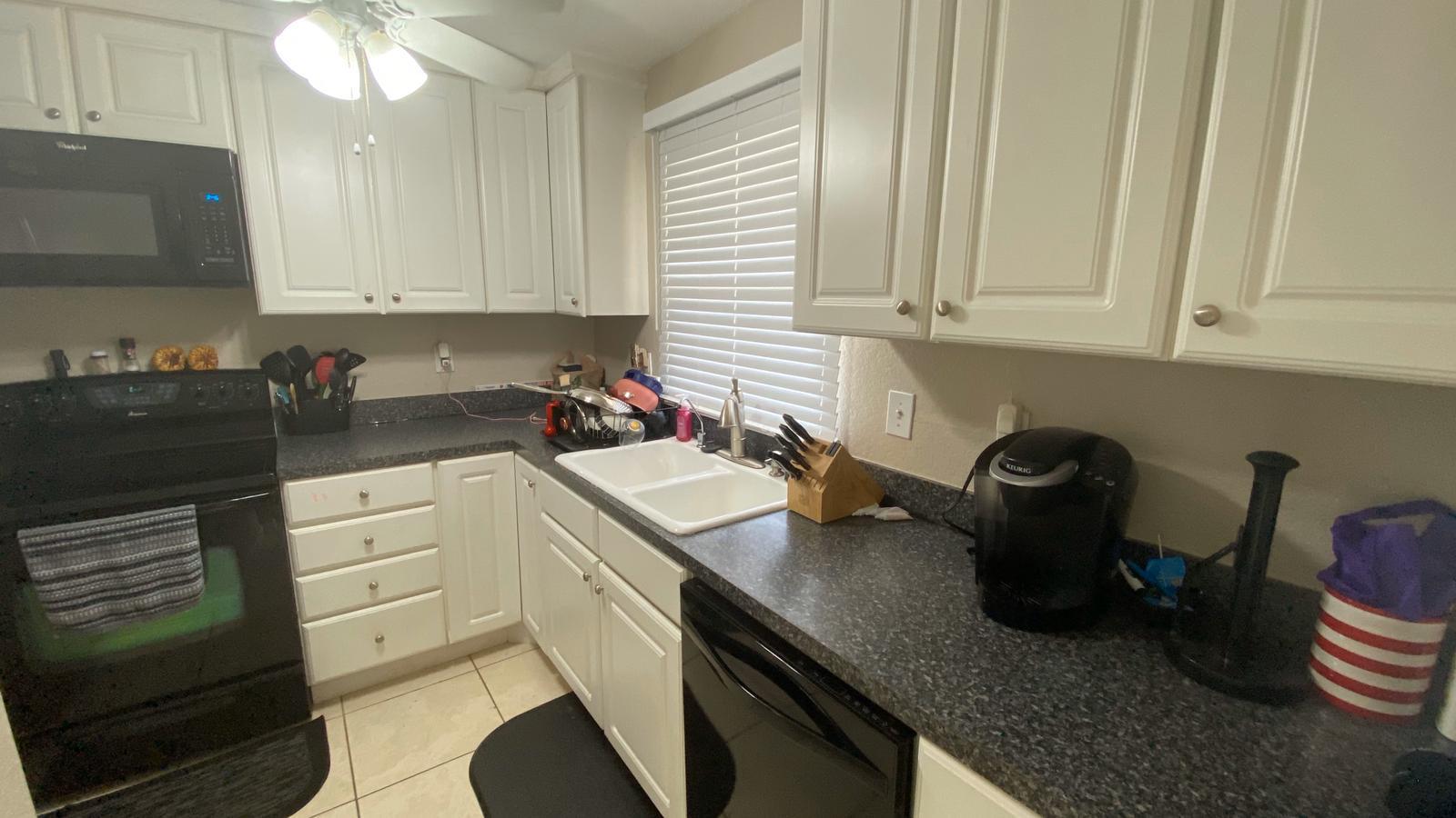 2628 Marcinski Road Jupiter, FL 33477 - Photo 7 of 18 a kitchen with a sink cabinets and appliances