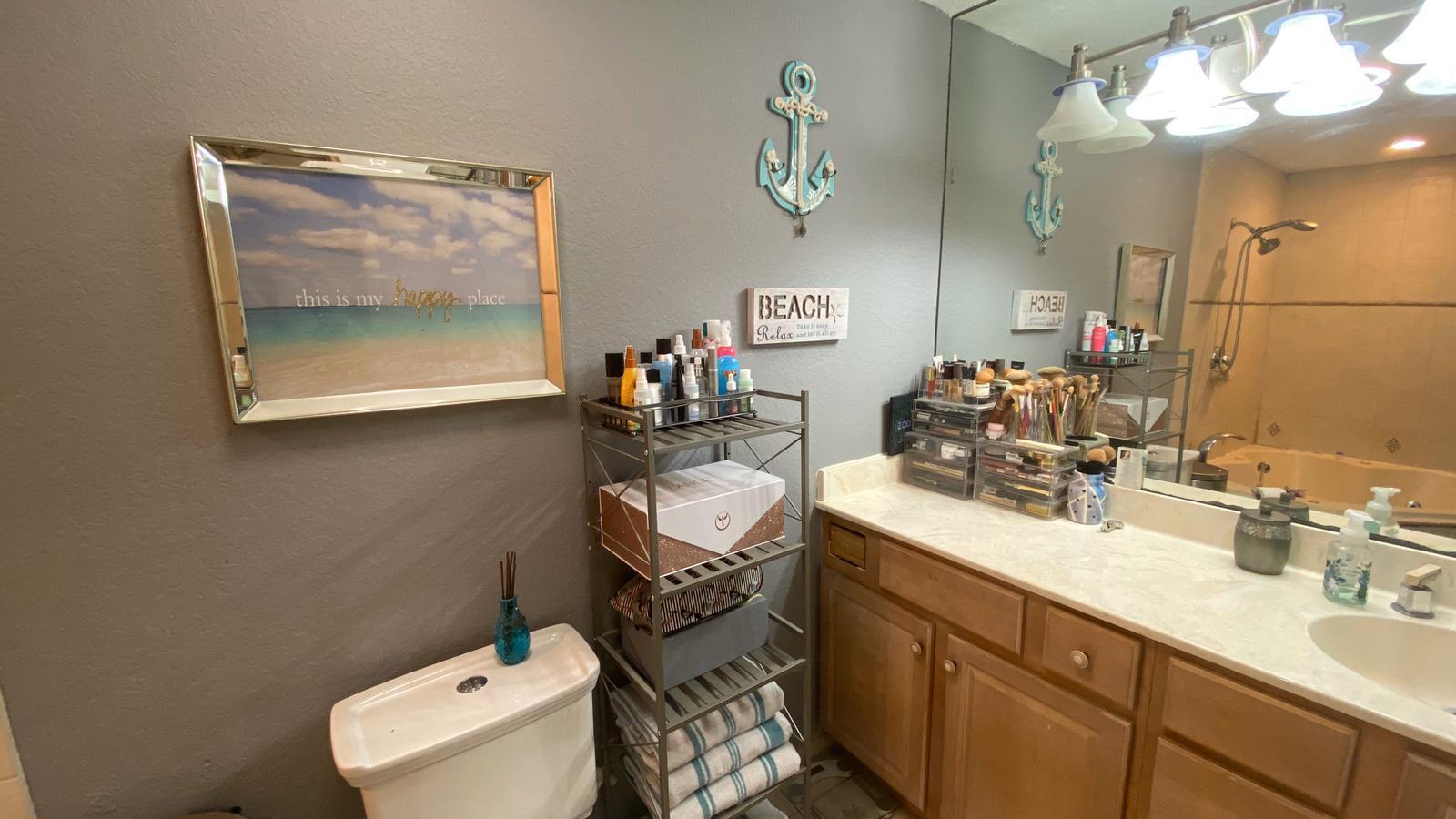 2628 Marcinski Road Jupiter, FL 33477 - Photo 9 of 18 a bathroom with a sink mirror and toilet