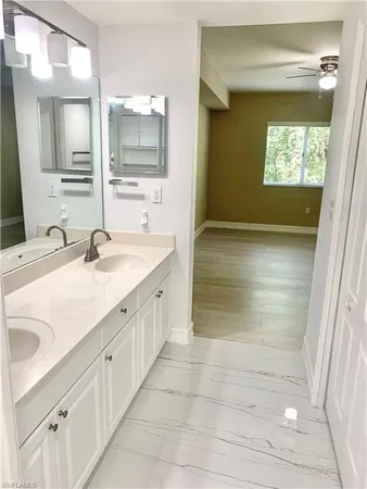 a bathroom with a sink a mirror and a shower