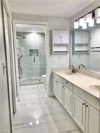 a bathroom with a granite countertop sink mirror and double