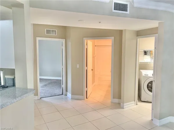 a view of a livingroom with wooden floor and a bathroom space