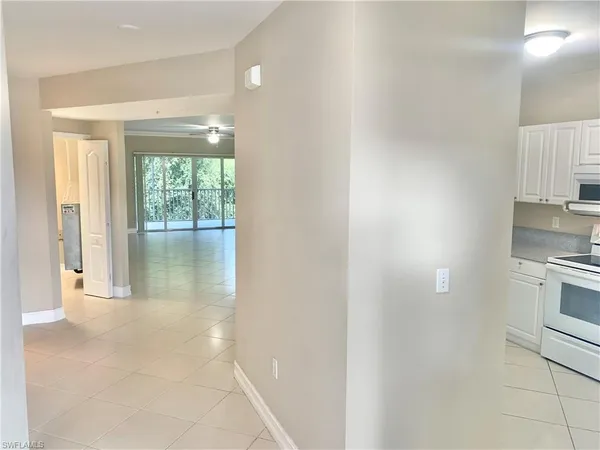 a view of a kitchen with a sink and dishwasher a stove top oven with wooden floor