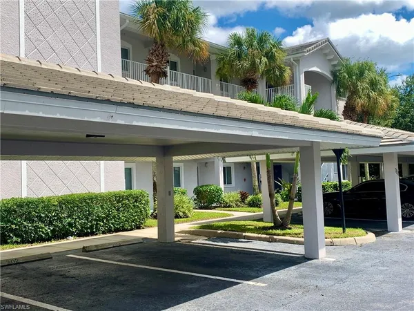a view of a lake with a house and a lawn chairs