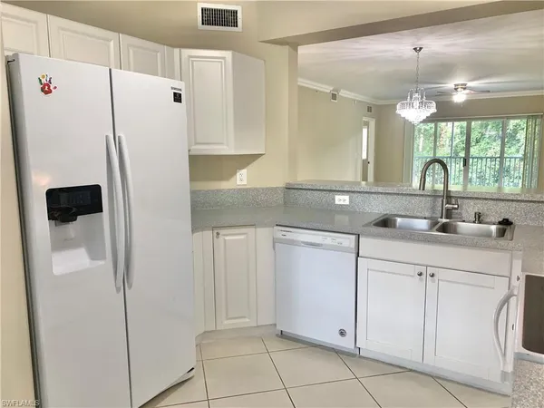 a kitchen with a sink and a refrigerator