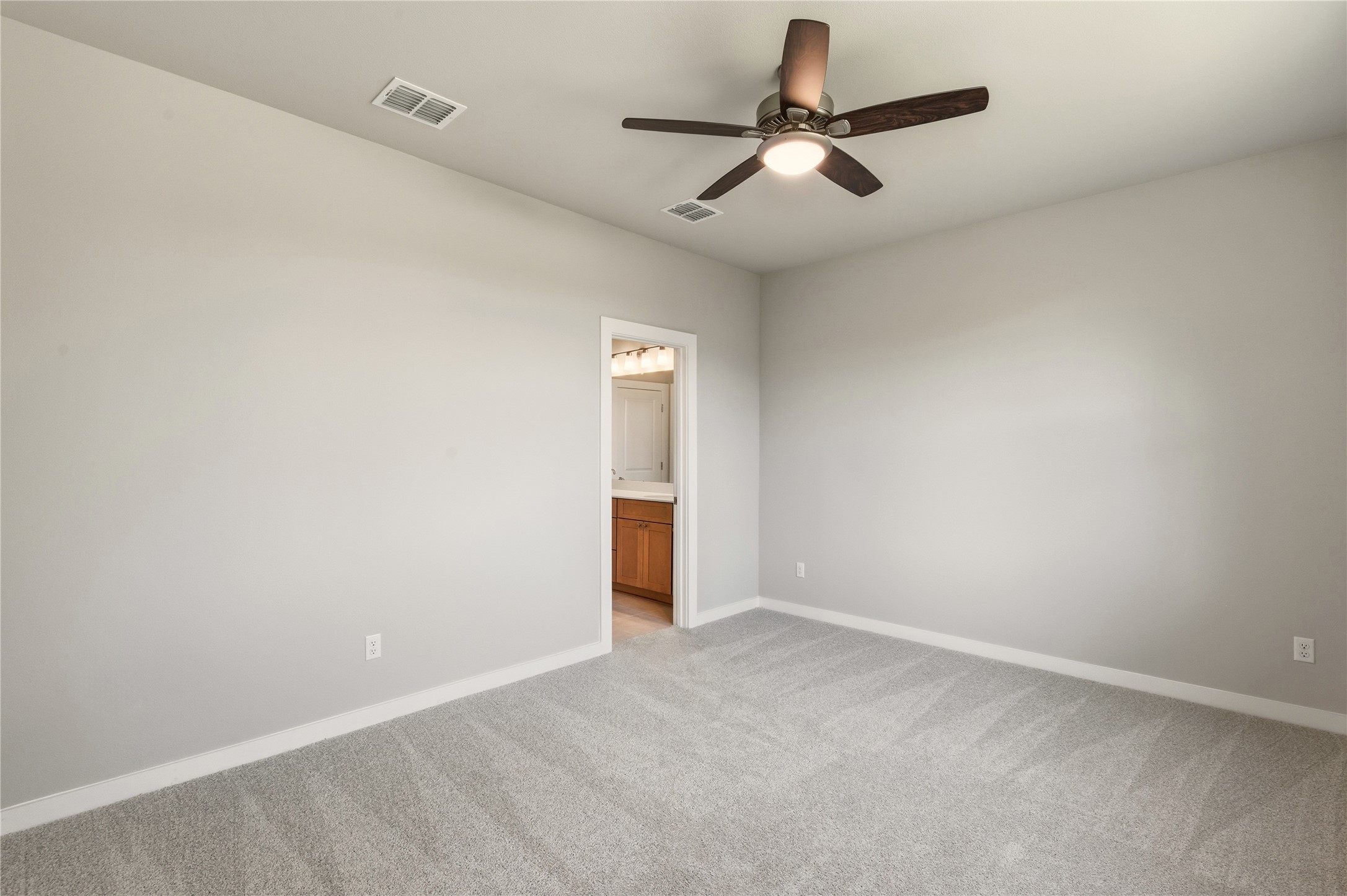 2201 Cento Walk Round Rock, TX 78664 - Photo 11 of 30 Unfurnished room featuring light colored carpet and a ceiling fan