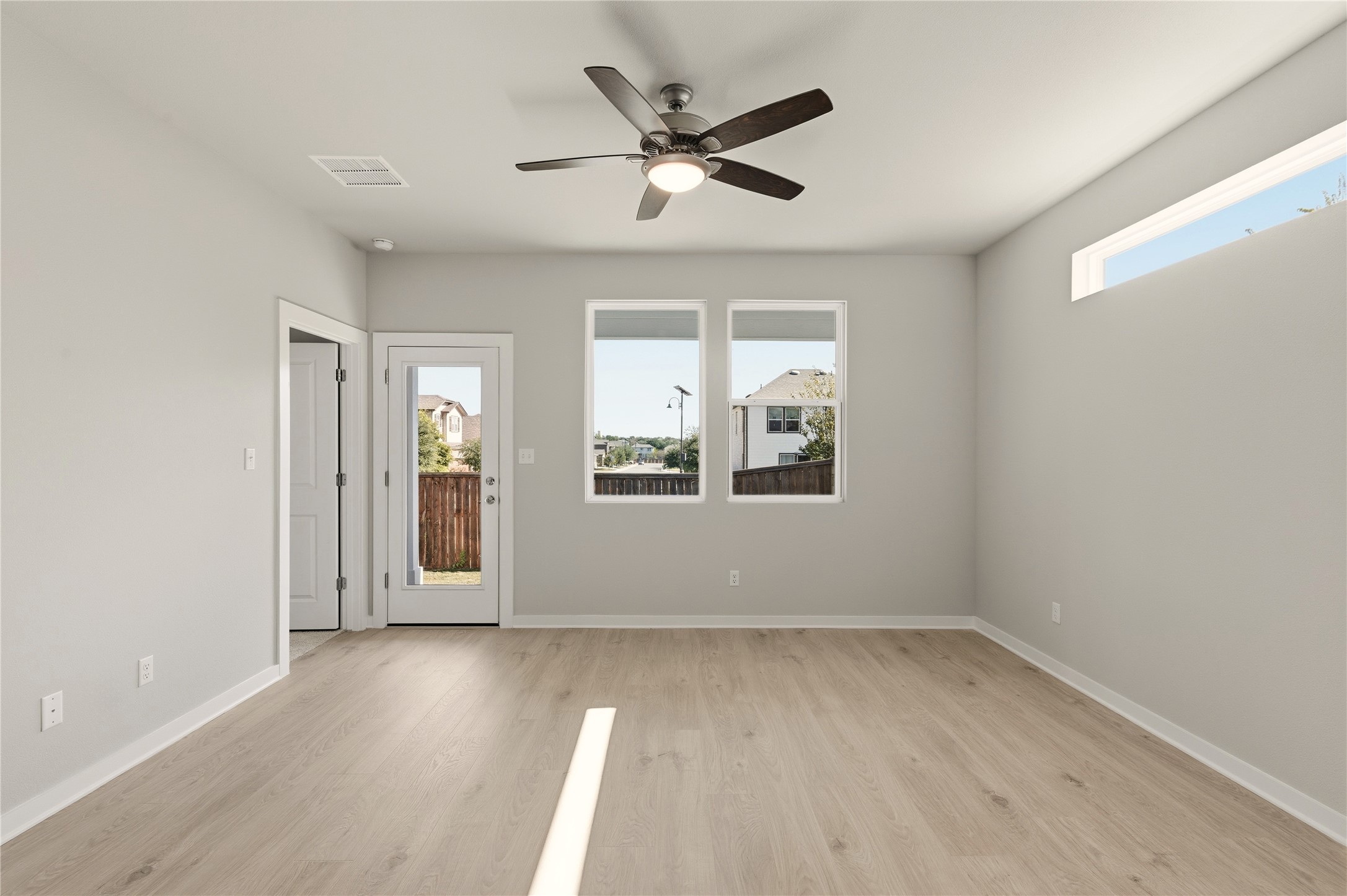 2201 Cento Walk Round Rock, TX 78664 - Photo 8 of 30 Empty room with light wood-style flooring and ceiling fan