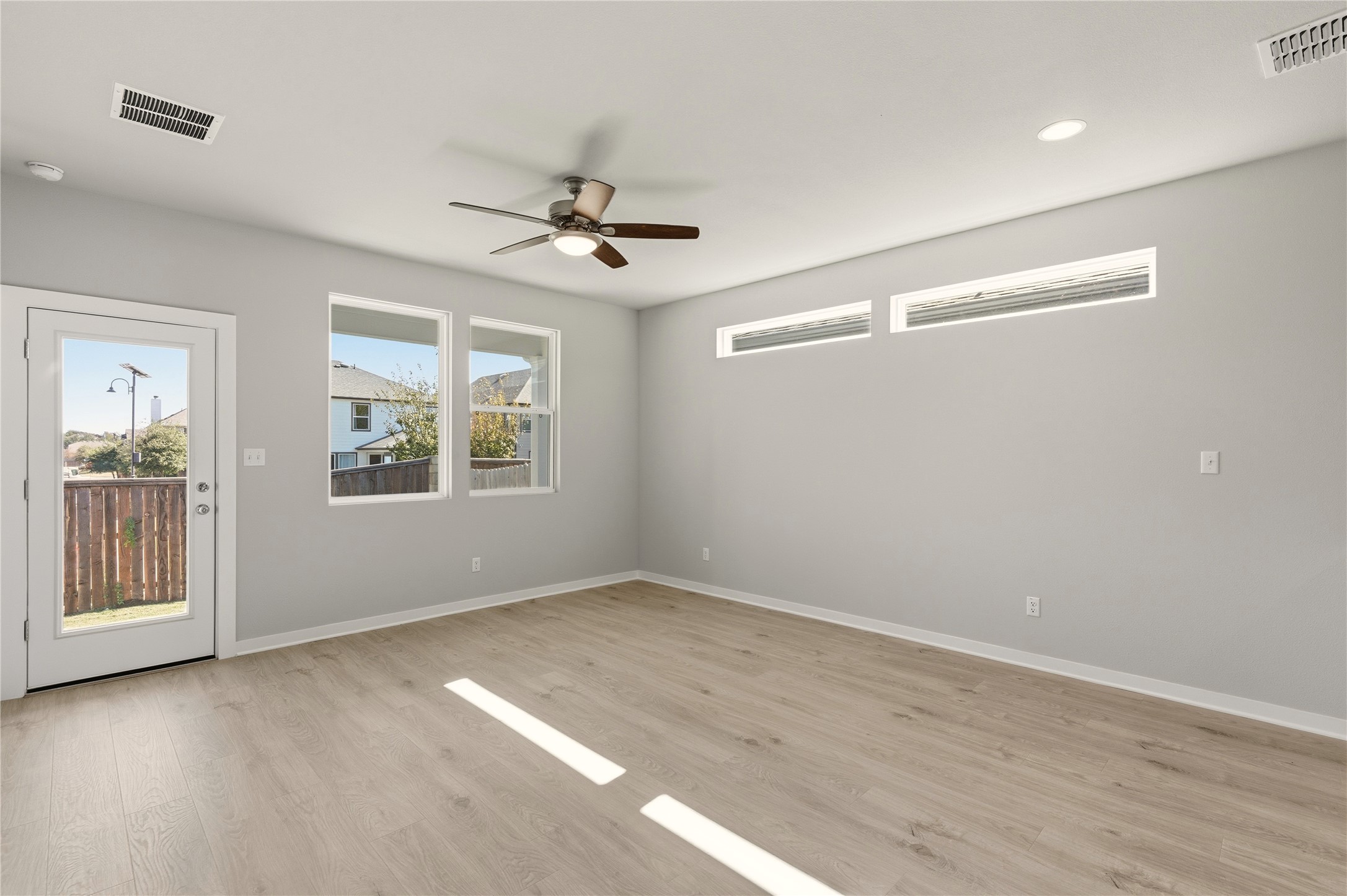2201 Cento Walk Round Rock, TX 78664 - Photo 10 of 30 Empty room featuring light wood-style flooring and ceiling fan