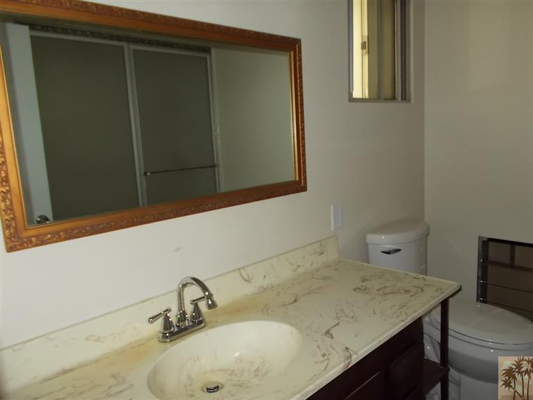 12478 Redbud Road Desert Hot Springs, CA 92240 - Photo 13 of 21 a bathroom with a sink and a mirror