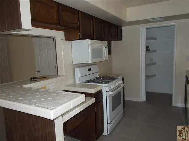 a kitchen with a stove and a refrigerator