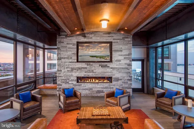 a living room with furniture stairs and a fireplace