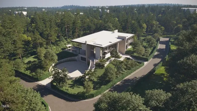 an aerial view of a house with a yard lake and mountain view