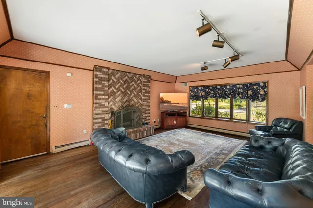 a open kitchen with stainless steel appliances granite countertop a stove top oven a sink dishwasher a dining table and chairs with wooden floor