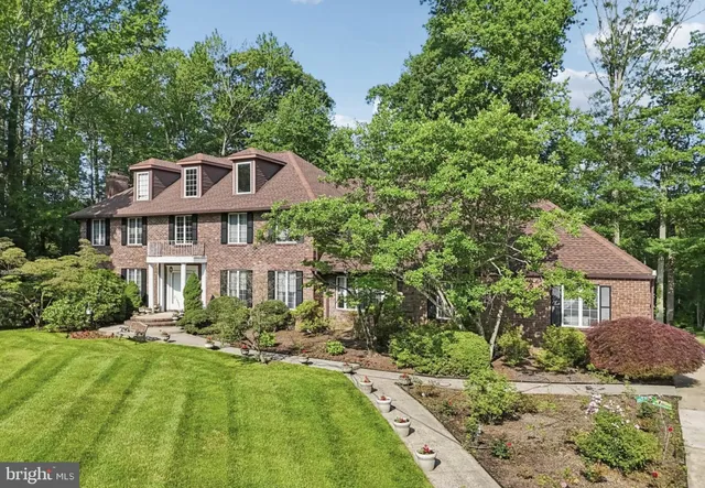 a view of front door with wooden floor and stairs