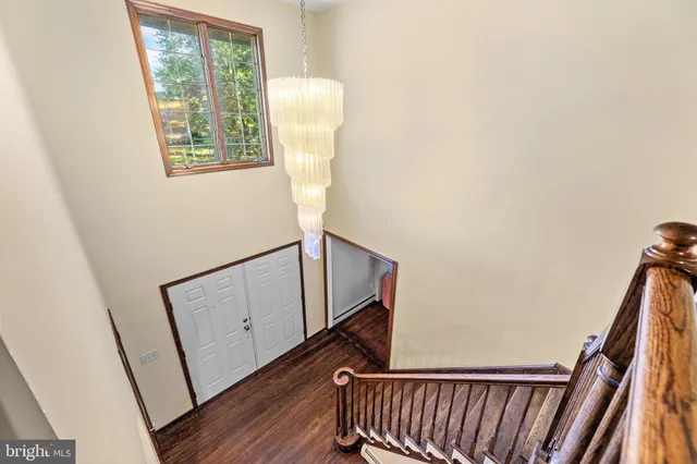 a view of a dining room with furniture wooden floor and chandelier
