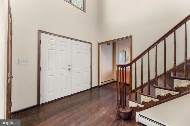 a view of a dining room with furniture a chandelier and wooden floor