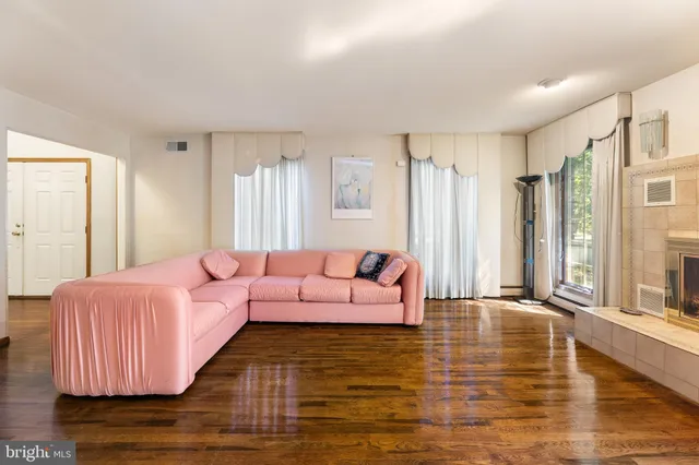 a bedroom with furniture and a large window