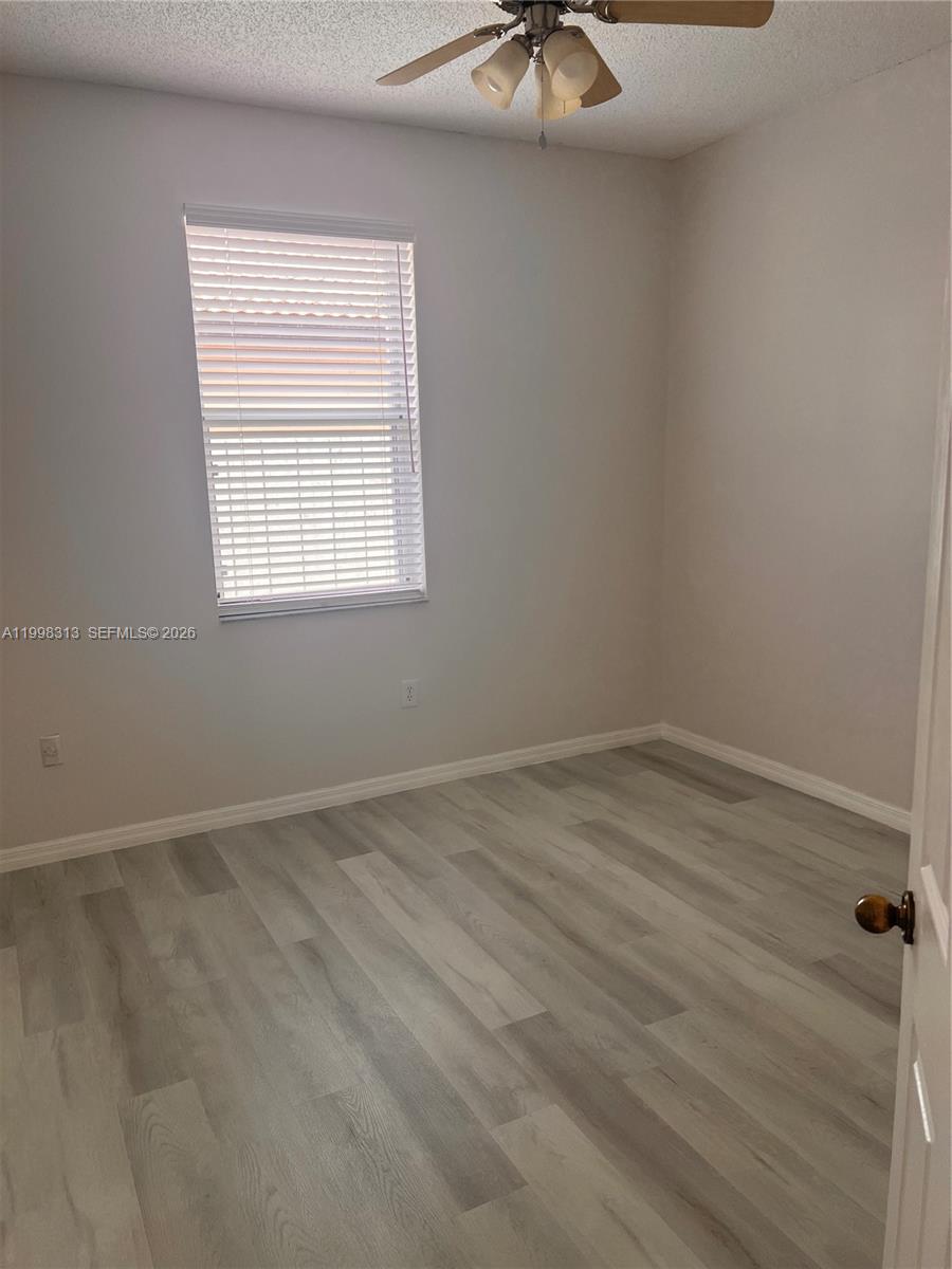 15761 Southwest 148th Terrace Miami, FL 33196 - Photo 11 of 17 an empty room with a window